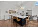 Bright kitchen with white marble countertops, an island with seating, stainless appliances, and hardwood floors at 3036 Palm Ave, Charlotte, NC 28205