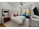 Bright primary bedroom with a large bed, stylish furnishings, and an abundance of natural light at 3036 Palm Ave, Charlotte, NC 28205