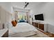 Bright main bedroom featuring a luxurious king bed, a ceiling fan, and a TV at 3036 Palm Ave, Charlotte, NC 28205