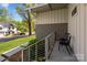 A modern porch with gray brick, seating for two, green shrubs, and a view of the street at 3036 Palm Ave, Charlotte, NC 28205