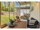 Relaxing screened-in porch with comfortable seating, stylish decor, and a view of the backyard at 3036 Palm Ave, Charlotte, NC 28205