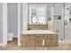 Inviting bathroom features a soaking tub, tile surround, glass enclosed shower, and ample natural light at 3068 Green Acres Ln, Claremont, NC 28610