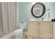 Small but functional bathroom with a toilet, vanity, and shower with a patterned curtain at 3068 Green Acres Ln, Claremont, NC 28610