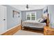 Comfortable bedroom with light blue walls and hardwood floors features a ceiling fan and natural light at 3068 Green Acres Ln, Claremont, NC 28610