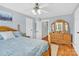 Well-lit bedroom with a wooden bed frame, spacious dresser, and natural light at 3068 Green Acres Ln, Claremont, NC 28610