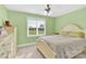 Sunlit bedroom with green walls, a comfortable bed, and a window offering a pleasant view at 3068 Green Acres Ln, Claremont, NC 28610