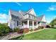 Beautifully landscaped home featuring a welcoming front porch and meticulously maintained lawn at 3068 Green Acres Ln, Claremont, NC 28610