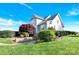 Well-manicured landscaping surrounds this home with a side entry, three-car garage with a stone accent wall at 3068 Green Acres Ln, Claremont, NC 28610