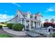 Charming two-story home with inviting porch and well-manicured landscaping, set against a clear blue sky at 3068 Green Acres Ln, Claremont, NC 28610