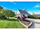 A well-maintained home with a beautifully landscaped yard and a curved driveway, enhancing curb appeal at 3068 Green Acres Ln, Claremont, NC 28610