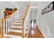 Bright foyer showcasing hardwood floors and an elegant staircase leading to the upper level at 3068 Green Acres Ln, Claremont, NC 28610