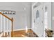 Inviting foyer featuring a decorative front door, hardwood floors, and staircase at 3068 Green Acres Ln, Claremont, NC 28610