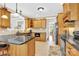 Well-lit kitchen featuring wooden cabinetry, granite countertops, and modern appliances at 3068 Green Acres Ln, Claremont, NC 28610