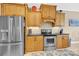 Traditional eat-in kitchen features light wood cabinets, granite counters, and stainless appliances at 3068 Green Acres Ln, Claremont, NC 28610