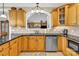 Traditional eat-in kitchen features light wood cabinets, granite counters, stainless appliances, and decorative tile backsplash at 3068 Green Acres Ln, Claremont, NC 28610
