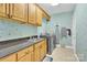 A charming laundry room is equipped with a stainless steel washer and dryer and built-in cabinetry at 3068 Green Acres Ln, Claremont, NC 28610