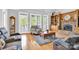 Cozy living room featuring hardwood floors, a stone fireplace, and ample natural light at 3068 Green Acres Ln, Claremont, NC 28610