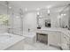A luxurious bathroom featuring a marble vanity, soaking tub, glass shower, and bright natural light at 311 Mcalway Rd, Charlotte, NC 28211