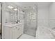 Bright bathroom with marble finishes, featuring a glass-enclosed shower and soaking tub at 311 Mcalway Rd, Charlotte, NC 28211
