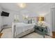 Bedroom with neutral colors, with large window, statement side table, and television at 311 Mcalway Rd, Charlotte, NC 28211