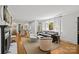 Bright living room with fireplace, hardwood floors, and lots of natural light, offering a cozy and inviting atmosphere at 311 Mcalway Rd, Charlotte, NC 28211