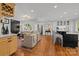 Open-concept living room with hardwood floors, stylish furnishings, and seamless flow to the kitchen at 311 Mcalway Rd, Charlotte, NC 28211