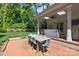 Charming outdoor dining area with a rustic table, seating for six, and a beautifully landscaped backyard at 311 Mcalway Rd, Charlotte, NC 28211