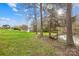 Spacious backyard with mature trees, a pond, and a swing, perfect for enjoying the outdoors at 32 Heritage Ln, Shelby, NC 28150