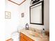 Well-lit half bath with a stylish vanity and decorative mirror, providing a convenient and elegant space at 32 Heritage Ln, Shelby, NC 28150