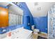 Bathroom with blue painted walls, a vanity with a modern sink, and bathtub with shower at 32 Heritage Ln, Shelby, NC 28150