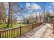 Large wooden deck overlooking lake with a playground set at 32 Heritage Ln, Shelby, NC 28150
