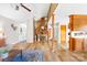 Open-concept living room with hardwood floors, a brick fireplace, and a view of the staircase at 32 Heritage Ln, Shelby, NC 28150