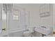 Clean, white bathroom features a tub/shower combo, classic tile, and vintage-style fixtures at 343 Wakefield Dr # C, Charlotte, NC 28209