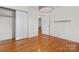 This is a standard bedroom with natural light and wood flooring with an ensuite bathroom and closet at 343 Wakefield Dr # C, Charlotte, NC 28209