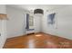 Neutral bedroom featuring hardwood floors, bright windows with neutral curtains and a modern drum shade light fixture at 343 Wakefield Dr # C, Charlotte, NC 28209