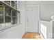 Bright hallway featuring a large window, hardwood floors and white trim at 343 Wakefield Dr # C, Charlotte, NC 28209