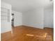 A spacious living room shows off hardwood floors and a built-in bookshelf in this home's living space at 343 Wakefield Dr # C, Charlotte, NC 28209