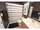 The dark bathroom features a shower, toilet, wood vanity, and decorative shower curtain at 346 Cornielle Ln, Charlotte, NC 28216