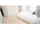 A bright bedroom features neutral decor, a queen bed with stylish bedding, and a door on the left at 346 Cornielle Ln, Charlotte, NC 28216