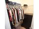 Organized walk-in closet with hanging clothes, shelving and a black dresser for optimal storage at 346 Cornielle Ln, Charlotte, NC 28216