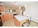 Cozy kitchen with an island, stainless sink, and adjacent staircase at 346 Cornielle Ln, Charlotte, NC 28216