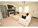 Bright living room featuring a comfortable sectional sofa, fireplace, and ample natural light at 346 Cornielle Ln, Charlotte, NC 28216