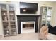 Cozy fireplace and shelves with large television in a nicely decorated living room at 346 Cornielle Ln, Charlotte, NC 28216