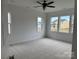 Bedroom with neutral carpet and plenty of natural light from the large windows at 4038 Gardenia Dr # 0114, Harrisburg, NC 28075