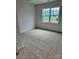 Bright bedroom with carpet and a large window overlooking a construction site at 4038 Gardenia Dr # 0114, Harrisburg, NC 28075