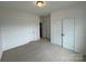 Bedroom featuring neutral carpet, closet, and hallway at 4038 Gardenia Dr # 0114, Harrisburg, NC 28075