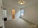 Comfortable bedroom with a window and two doors leading to other areas of the house at 4038 Gardenia Dr # 0114, Harrisburg, NC 28075