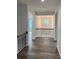 Second floor hallway with chandelier and iron railing at 4038 Gardenia Dr # 0114, Harrisburg, NC 28075