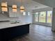 Bright kitchen with a center island, quartz countertops, stainless steel appliances, and an eat-in breakfast area at 4038 Gardenia Dr # 0114, Harrisburg, NC 28075
