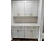 Additional kitchen space features white cabinets with gold hardware, quartz countertops and hardwood flooring at 4038 Gardenia Dr # 0114, Harrisburg, NC 28075